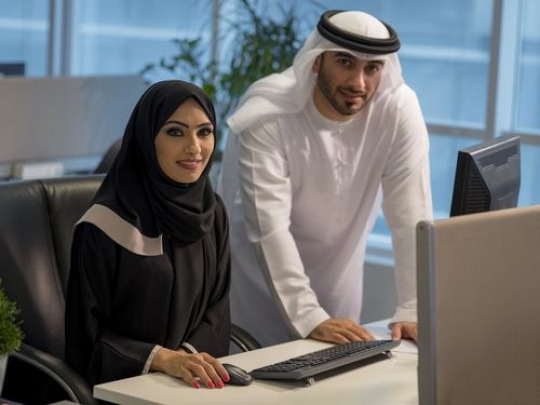Business man and business woman smiling|