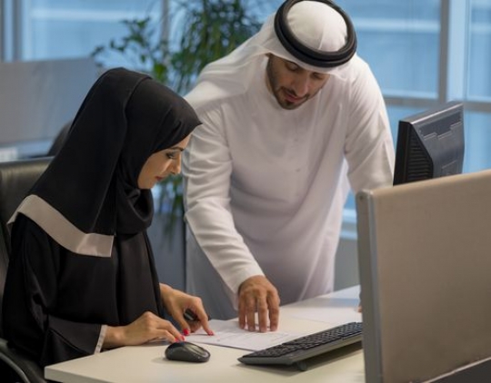 Businessman and business woman at the office working together|