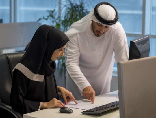 Businessman talking to business woman about work|