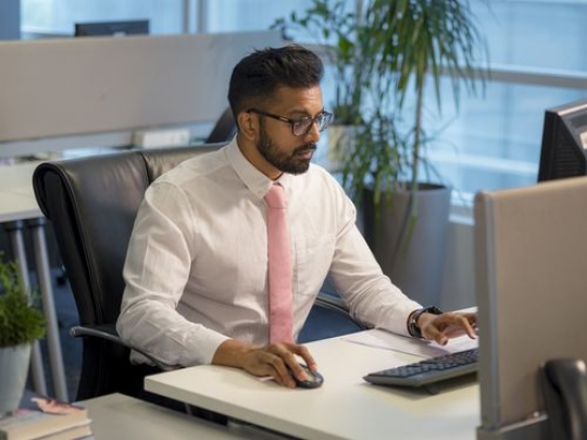 Business man sitting by his desk at the office|