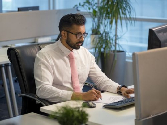 Business man at the office sitting by his desk|