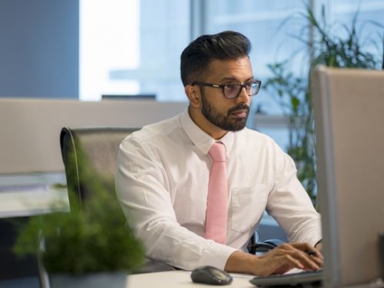 Business man sitting by his desk|