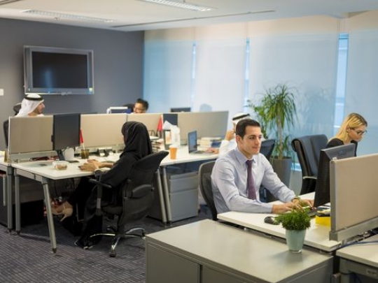 Employees at their desk at the office working|