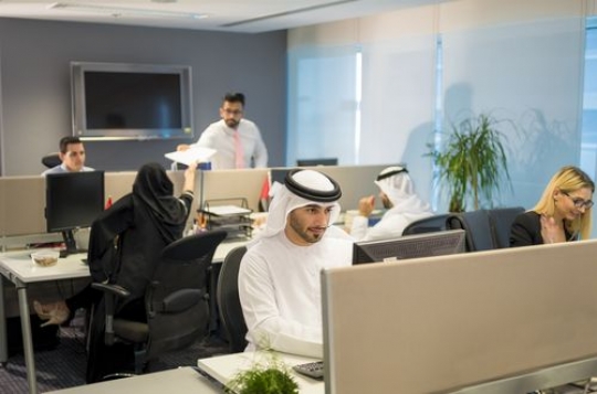 Business people sitting by their desk at the office|