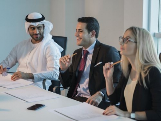Arab business man and western business woman during a meeting|-
