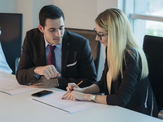 Two colleagues during a meeting at the office|-