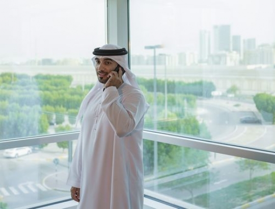Arab man making a phone call|-