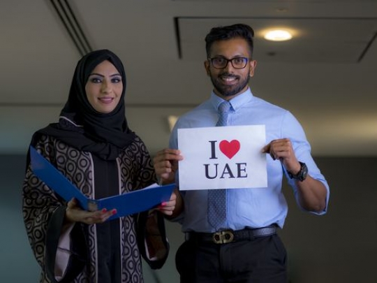 Medium shot of a businessman and a business woman celebrating National Day|-