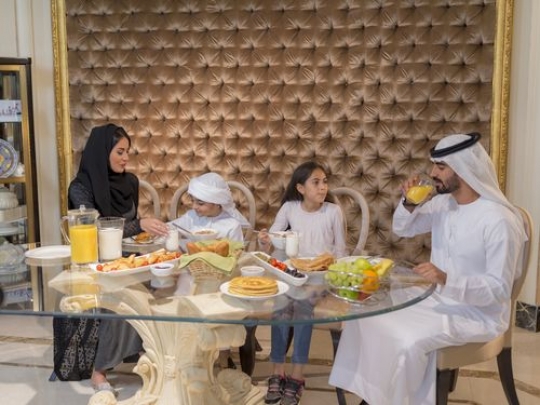 Arab family sitting together during breakfast|-