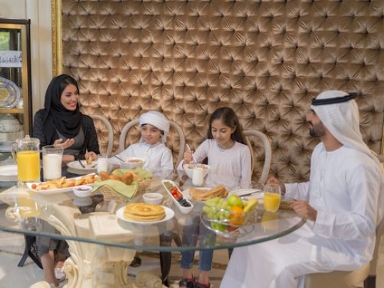 Family sitting all together during breakfast|-
