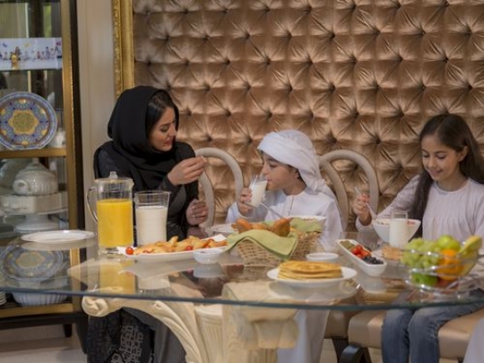 Arab mother and her kids sitting together|-