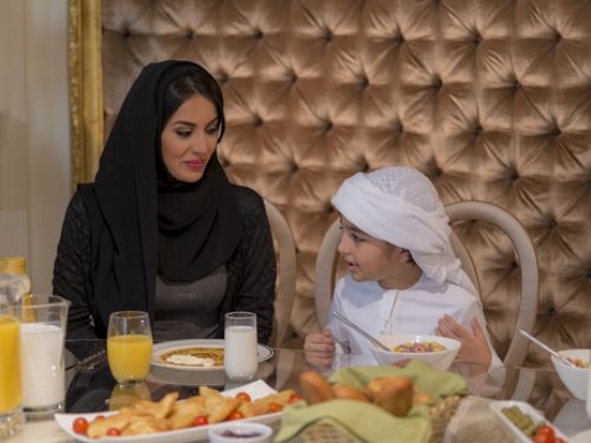 Arab mother and her son sitting together|-