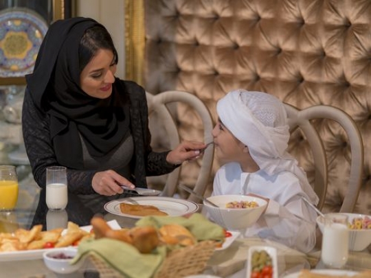 Arab mother feeding her son |-