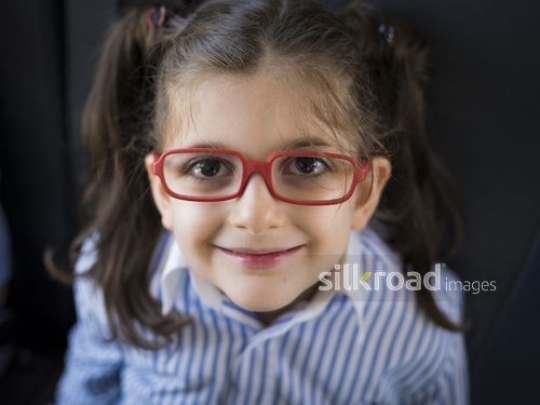 Close up of a Middle Eastern student wearing red glasses|-