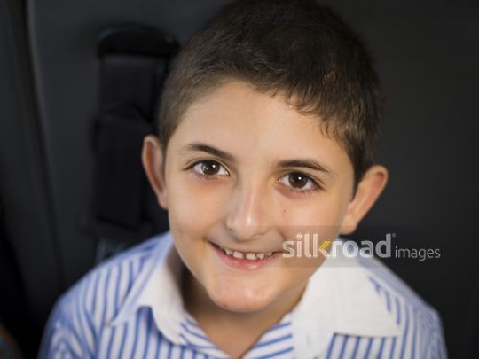 Portrait of a Middle Eastern boy smiling|-