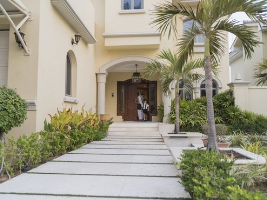 Arab man and boy leaving the house|-