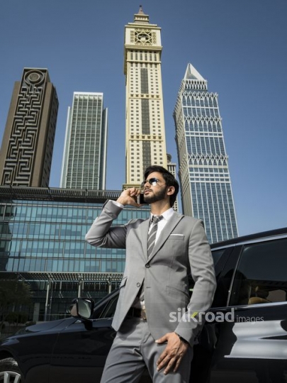 Businessman standing talking on the phone|-