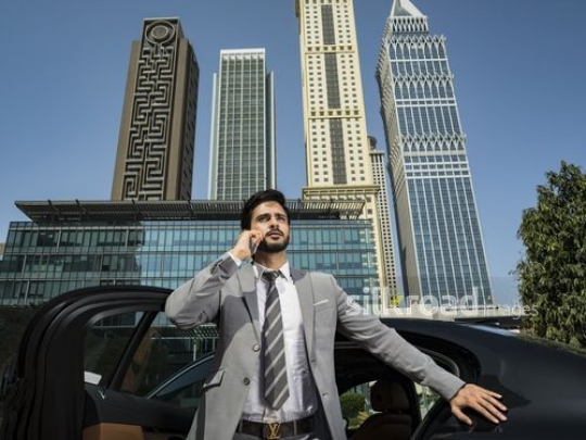 Businessman standing using his phone|-