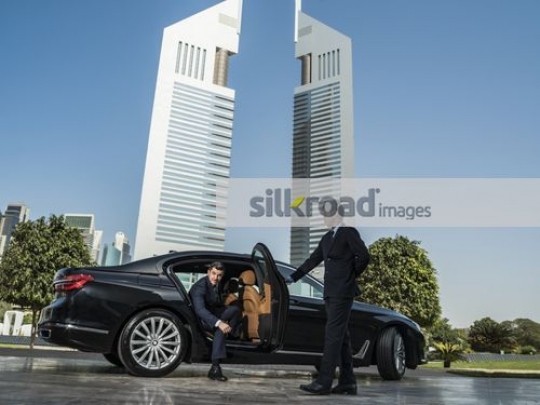 Young Western Businessman getting out of the car|