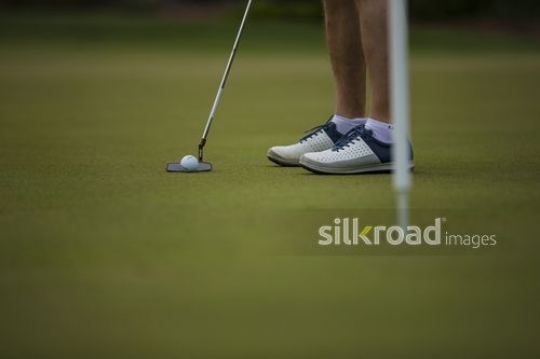 A man is playing golf on a golf course|-