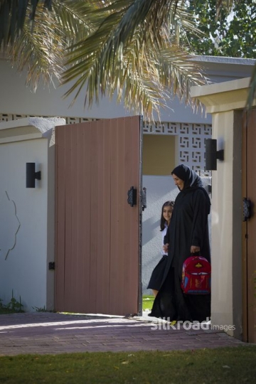 Middle Eastern mother and daughter walking outside |-