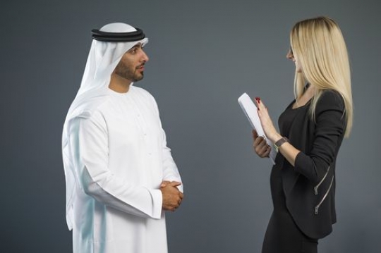 Portrait of an arab business man and a western woman at the office|