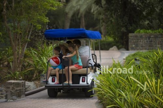 Family in golf cart|-