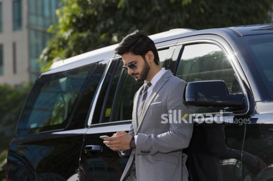Medium Shot of a Businessman using his mobile|-