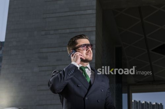 Medium Shot of a Western Businessman on the phone|-