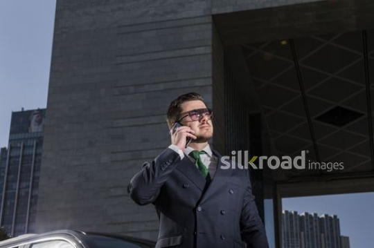 Western Businessman using his mobile|-