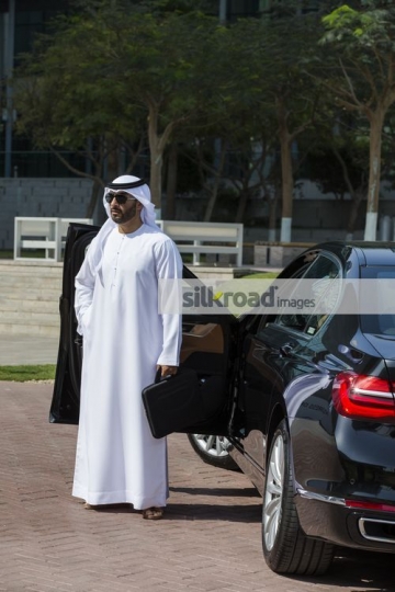 Middle Eastern Businessman standing by the car|