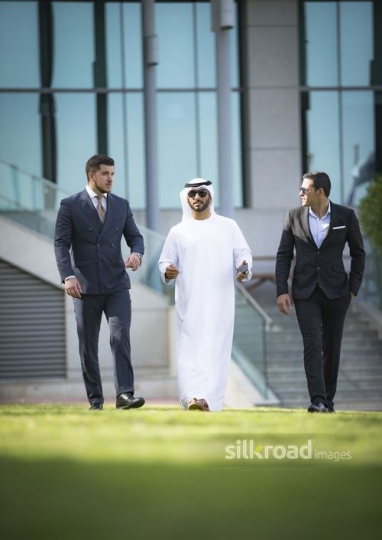 A group of Businessmen walking all together|-