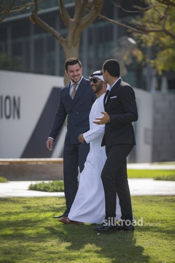A group of Businessmen walking and laughing together|-