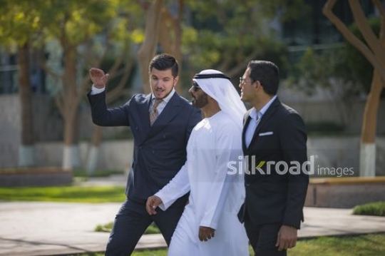 Businessmen walking outside all together|-