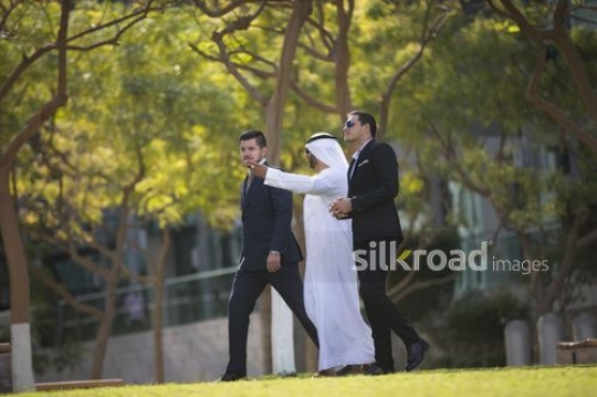 A group of Businessmen walking all together|-