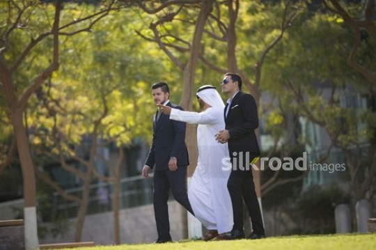 Group of successful businessmen walking together|-