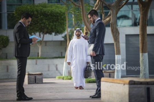 Successful Middle Eastern businessman walking towards his colleagues|-