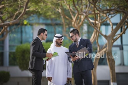 Western Businessman talking to his Middle Eastern colleagues|-