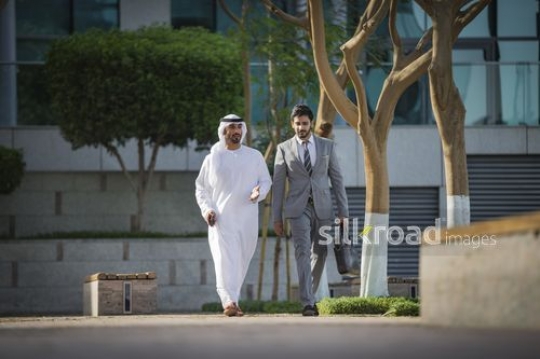 Two Colleagues walking together outside |-