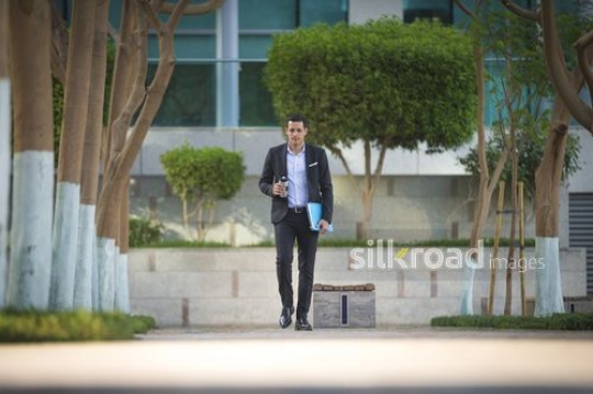 Arab businessman walking|-