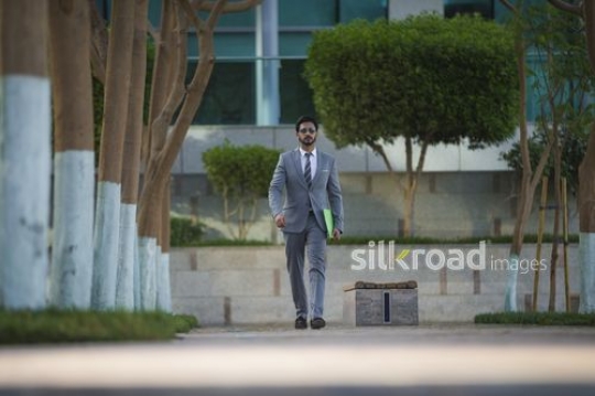 Expat Businessman walking|-