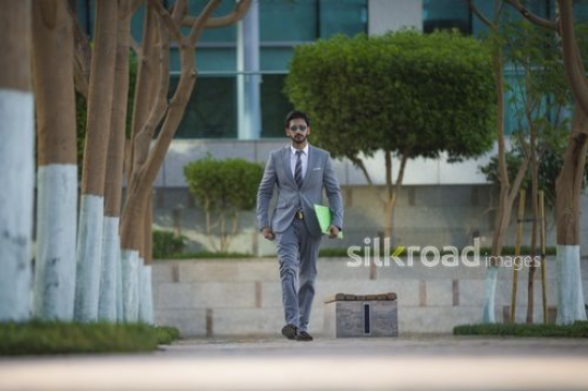 Successful Businessman walking and talking on the phone|-