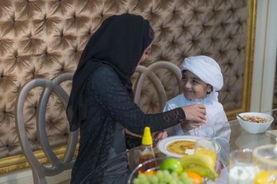 Arab mother sitting with her son|-