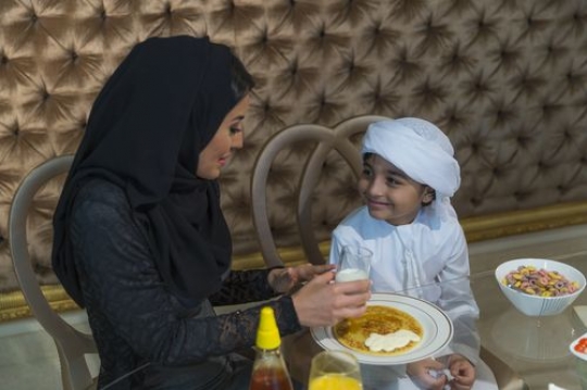 Middle eastern mother sitting with her son|-