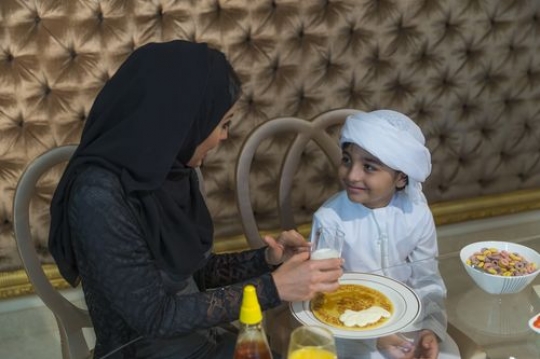 Arab woman and boy sitting together|-