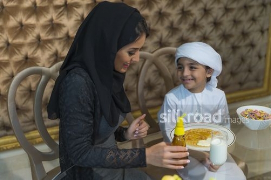 Middle Eastern mother and son bonding during breakfast|
