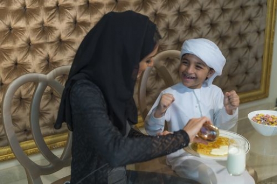 Arab mother preparing her sons breakfast |-