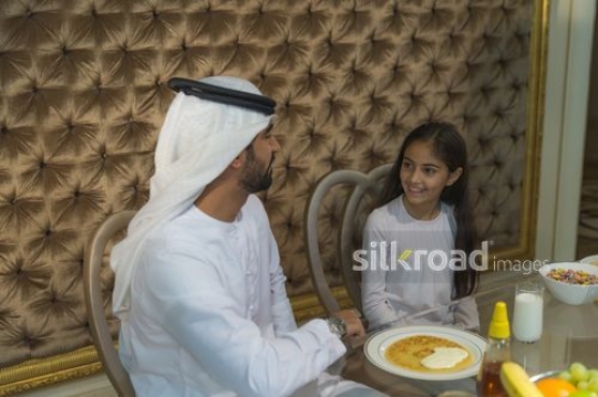 Middle Eastern father bonding with his daughter during breakfast|