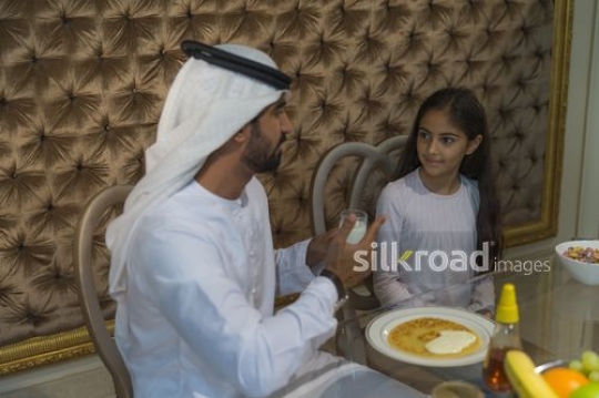 Middle Eastern father and daughter bonding during breakfast|