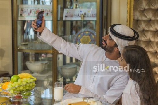 Arab father and daughter selfie together|